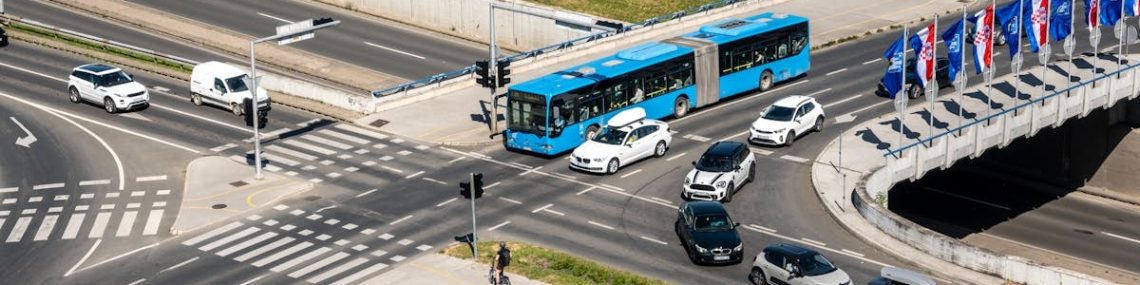 Aerial shot of a bustling traffic intersection with cars and a bus in Zagreb, Croatia.